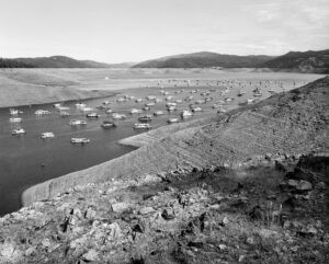 A black and white photo of boats in the water Mimi Plumb The Reservoir