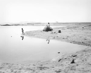 Mimi Plumb The Reservoir Family standing on the shore of a body of water